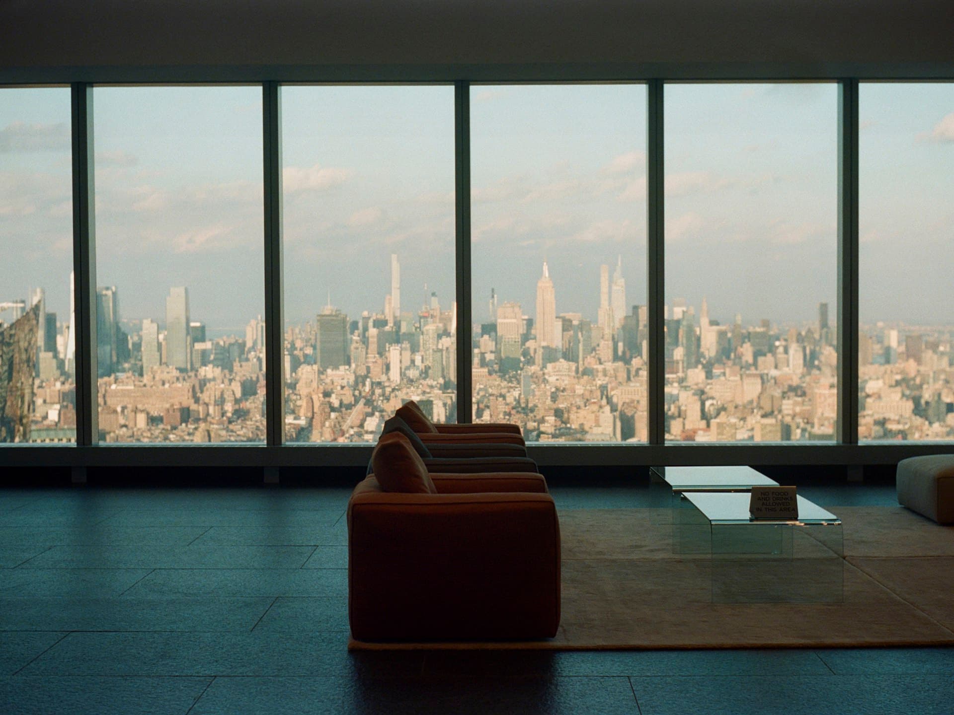 Penthouse living room with panoramic city skyline view